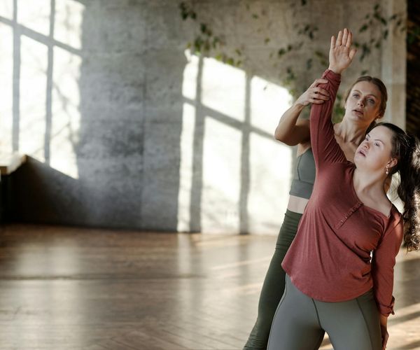 Person stretching in a bright, sunlit room, feeling energized.
